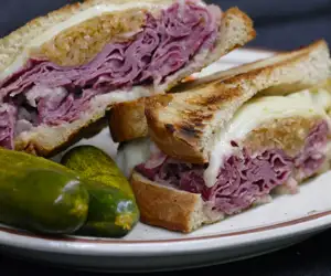 Ruben sandwich with pickles. 