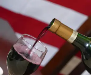 Pouring a glass of red wine. 