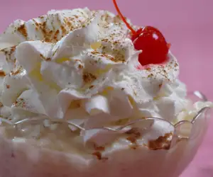 Ice cream dessert topped with whipped cream. 